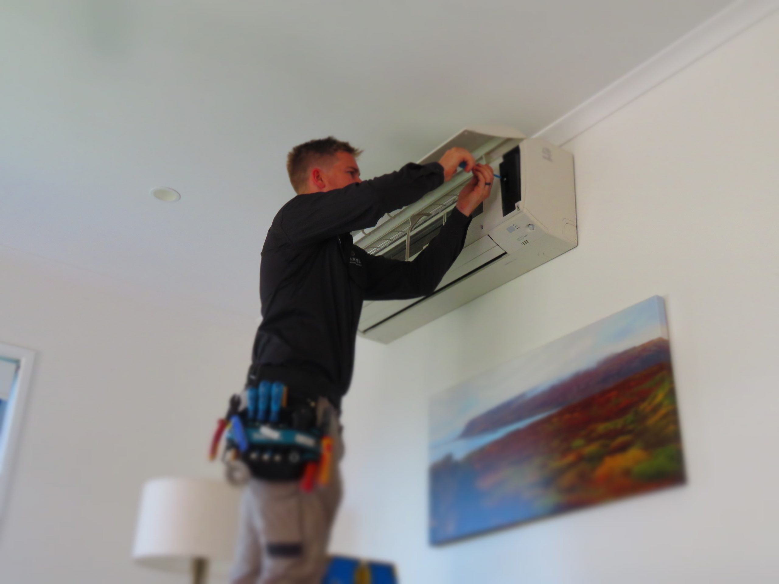 air con 2 man repairing split system air conditioner