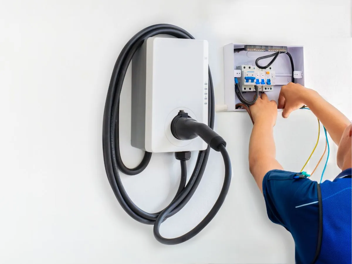 person installing an ev charger